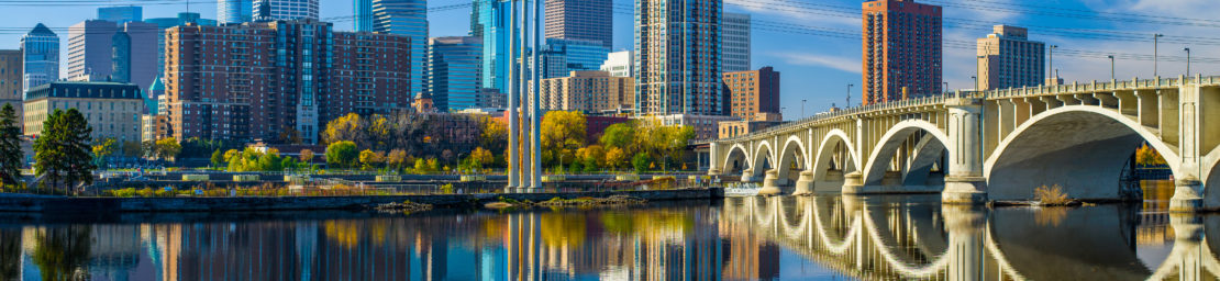 the 3rd avenue bridge crosses over the mississippi river toward the minneapolis skyline, autumn